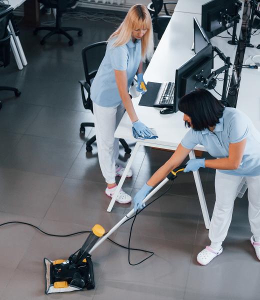 Concentrated at job. Group of workers clean modern office together at daytime.